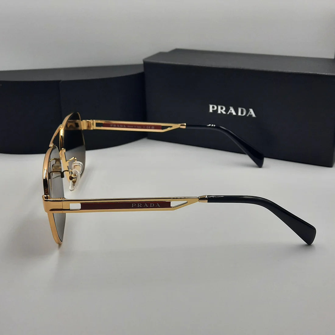 PRADA OPS51ZS rouge doré marron