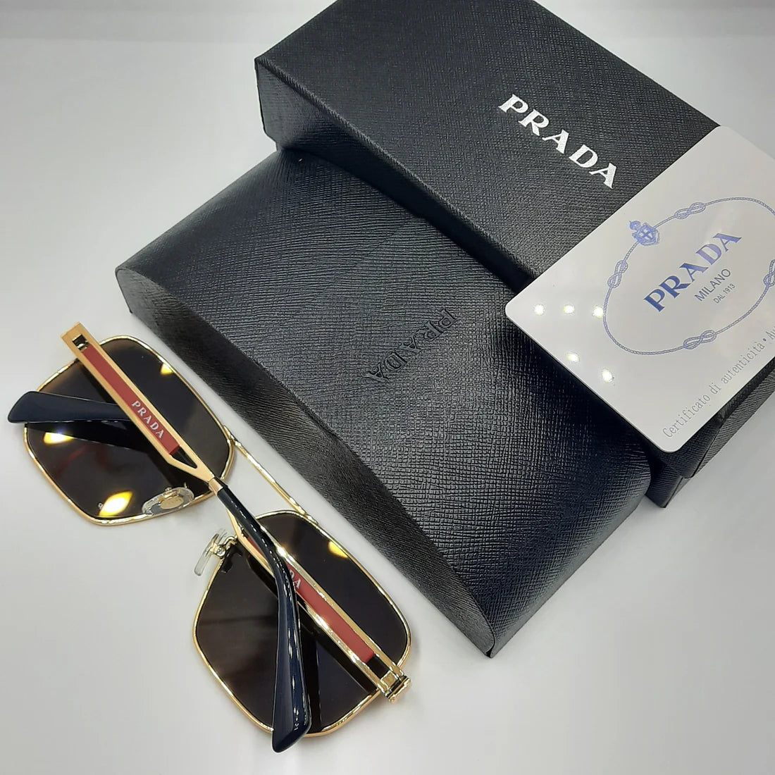 PRADA OPS51ZS rouge doré marron